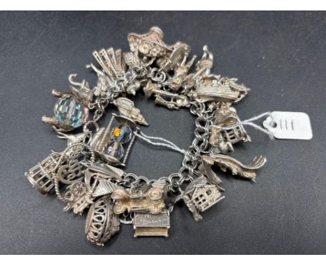 An exceptional very heavy silver charm bracelet with over 30 charms 133 g.