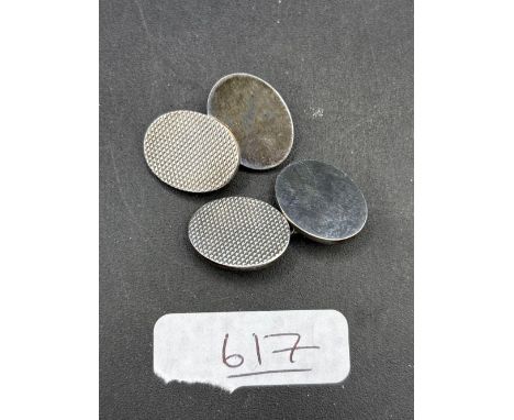A pair of heavy silver cufflinks