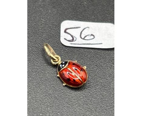 A novelty high carat gold and enamel ladybird pendant