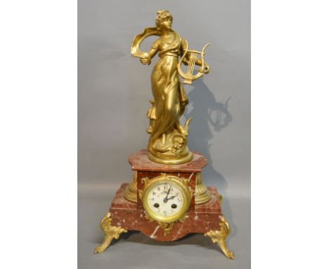 A 19th Century French Variegated Marble and Gilt Metal Mantle Clock surmounted with a Classical Female with Harp, the rouge m