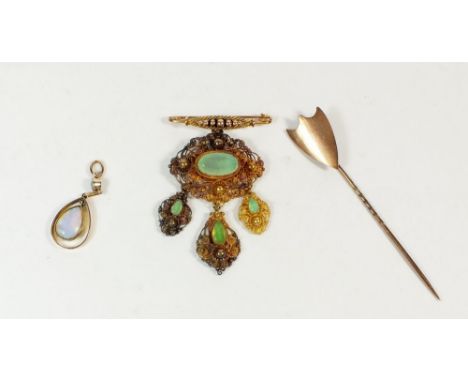 A continental filigree pendant set green stones on replacement bar brooch plus yellow metal and opal pendant and a shield for