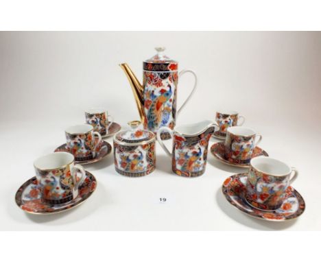 A Japanese coffee set with printed peacock decoration comprising: coffee pot, milk, sugar, six cups and saucers