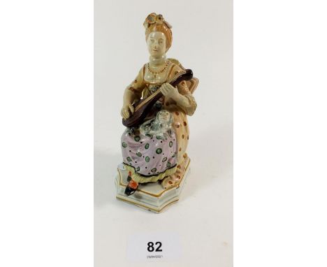 A 19th century Pearlware figure of a woman seated playing a lyre, with books and lute below chair and dog to her lap, 14.5cm 