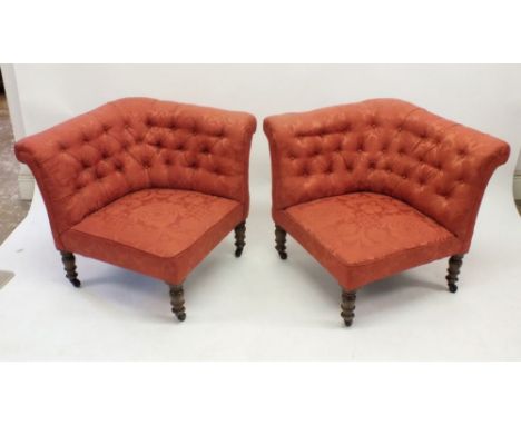 A pair of Victorian coral pink button upholstered corner armchairs on turned supports - can be placed together to form a smal