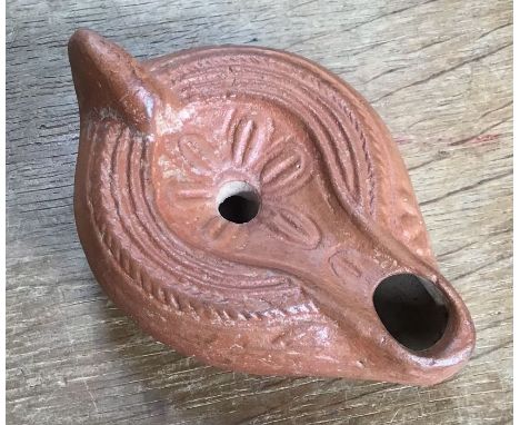 Late Roman North African Grave Offering&nbsp;Decorated Samian oil lamp. Approximately 11cm long and 4.5cm high.