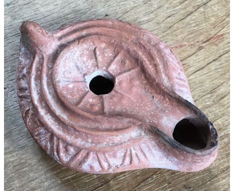 Late Roman North African Grave Offering&nbsp;Decorated Samian oil lamp. Approximately 11cm long and 4cm high.