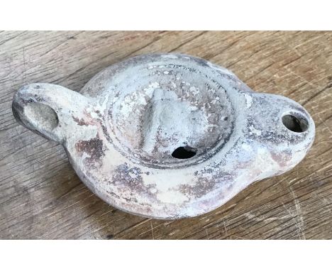 Late Roman North African Grave Offering decorated oil lamp.&nbsp;Approximately 11cm long and 5cm high. Signed on base.