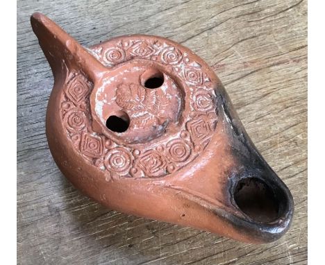 Late Roman North African Grave Offering&nbsp;Decorated Samian oil lamp. Approximately 13cm long and 5cm high.