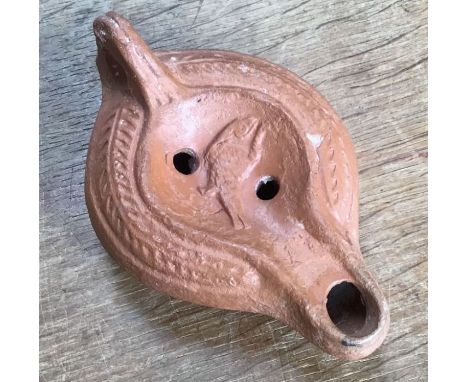 Late Roman North African Grave Offering&nbsp;Decorated Samian oil lamp. Approximately 12cm long and 5cm high.