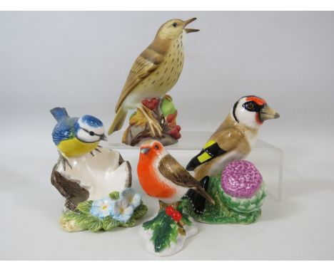 Royal Worcester Thrush figurine and 3 John Beswick bird figurines.