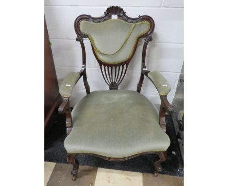 Nicely made Regency Style Armchair with good carved detail to the Mahogany Frame.   Raised on original metal and ceramic cast