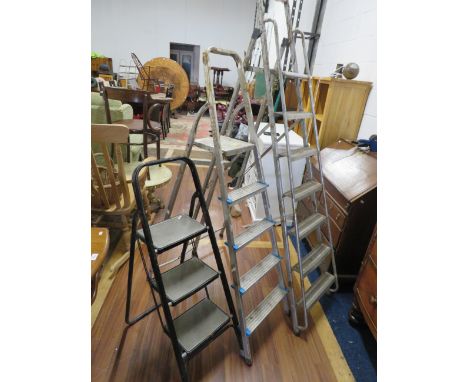 Three sets of metal step ladders the tallest being 74 inches tall. See photos.  S2