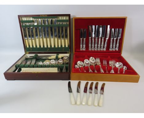 Two boxed cutlery sets and a set of mother of pearl handle butter knives.