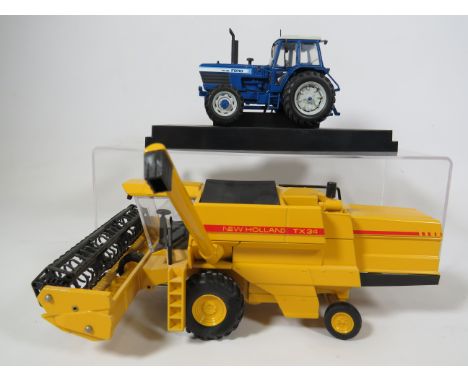 Two Die Cast models, New Holland Haverster &amp; Tractor. Both Ex display conditon.  See photos. 