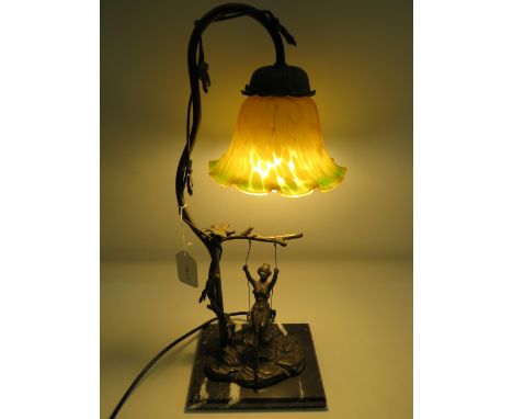 Spelter figural table lamp of a lady on a swing. Orange/Green Shade. Working order. See photos. 