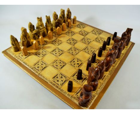 Lovely Chess set having a raised Ceramic tiled base with hard glazed chess pieces.  Tallest chess piece measures almost 4 inc
