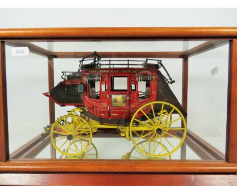 Franklin Mint Detailed model of a Wells Fargo overland stagecoach. Housed in a wooden framed glass case with mirror base.  H: