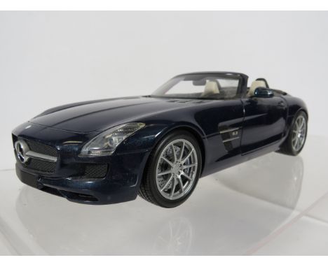 Minichamps 1:18 Scale Model of a 2011 Mercedes Benz AMG Roadster with original box and packaging.  Ex display condition.  See