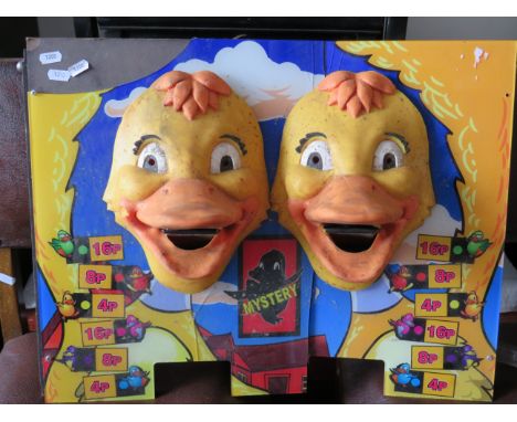 amusing panel from a gaming machine which has two rubber duck heads.  Novelty item for decorative purposes only.  23 x 16 inc