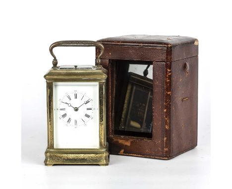 A 19th century French carriage clock with an engraved brass case, enamelled dial with Arabic and Roman numerals, 9cm wide x 7
