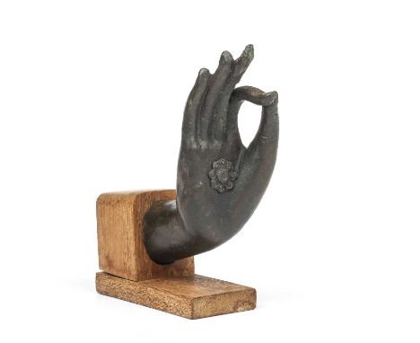 A Bronze hand of Buddha Cast with thin and elongated fingers in the vitarka mudra gesture on a later stand 12cm x 8cm. From a