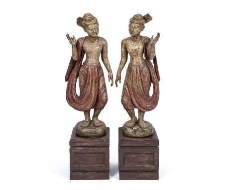 A pair of 20th century carved and painted hardwood Eastern figures each on plinths, 31cm wide x 117cm high overallAt present,