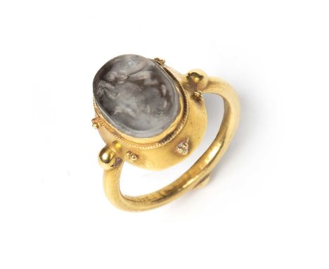 A Sasanian style rock crystal intaglio carved with a rabbit and mounted in a yellow metal ring, the stone 1cm x 1.5cm.