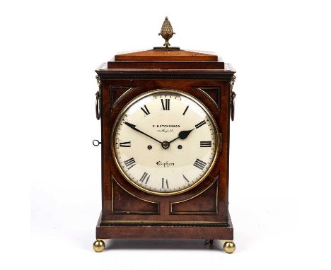 A Regency mahogany bracket clock with a pineapple finial a brass bound case with side carrying handles and side fishscale sou