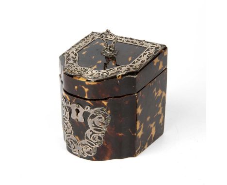 An Edwardian tortoiseshell veneered tea caddy of slope top cutlery box form, applied silver strapwork mounts to the top and f