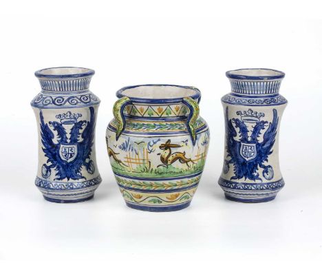 A pair of majolica glazed albarello each with blue and white double eagle crests, 13cm diameter x 23cm high together with a f