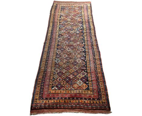 An antique South Persian runner possibly Luri, with a multiple banded border and lattice design, 118cm x 355cmLight overall w