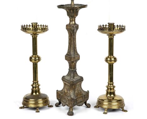 A pair of ecclesiastical brass candlesticks converted to lamps, overall 61cm high together with an antique continental presse