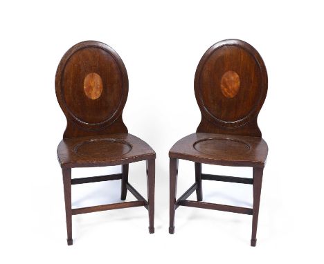 A pair of Georgian hall chairs with oval backs and square tapering legs terminating in spade feet, 48cm wide x 42cm deep x 45