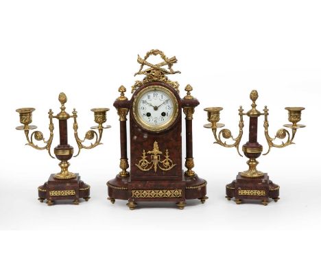 A French red marble and gilt metal garniture de cheminee clock, the enamelled dial with Arabic numeral, overall 22cm, wide 33