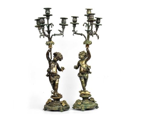 An Impressive near pair of 19th century Louis XVI style French bronze four branch candelabras of cherub form adorned with gra