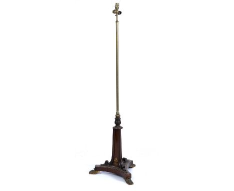 A Regency brass and rosewood adjustable standard lamp with a triform base and gilt metal paw feet, 45cm wide x 137cm highUnte