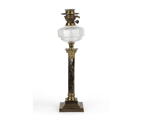 A late 19th / early 20th century German oil lamp with a cut glass well, a marble enamelled Corinthian column and a stepped ba