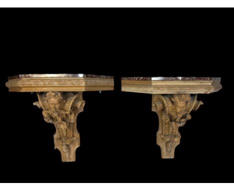A pair of 19th century Renaissance style stripped pine carved console tables
With trapezoidal brescia marble tops above grote