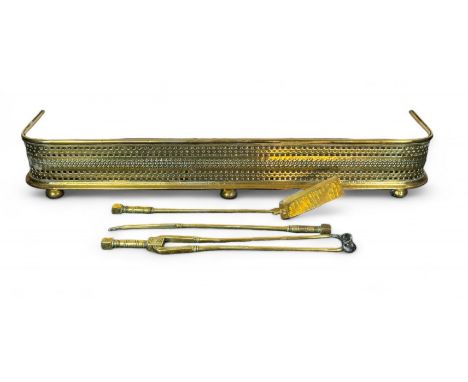 A Victorian brass fender, a set of brass firetools and two scuttles
The fender of rounded rectangular form on turned feet, 12