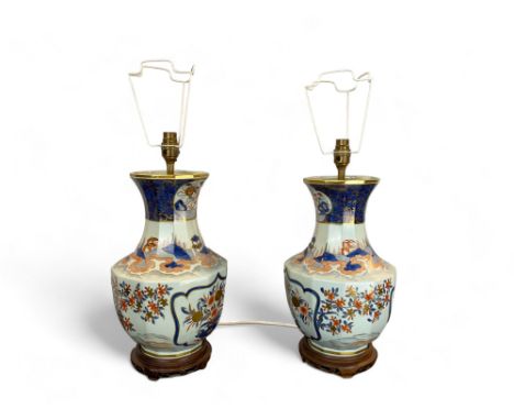A pair of 20th century Imari style porcelain table lamp bases
Of faceted baluster form, on turned wood bases, together with a