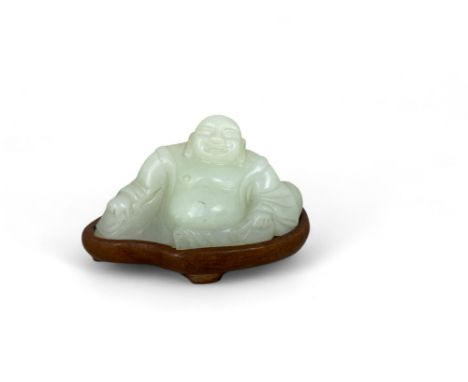 A jade seated Buddha on a hardwood stand
8cm wide