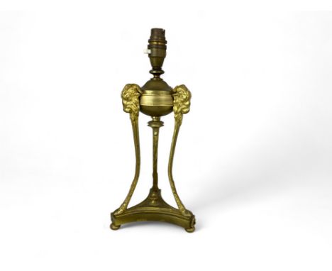 A late 19th century neo-classical style gilt bronze table lamp
The reservoir on tripod ram's head supports with hoof feet and