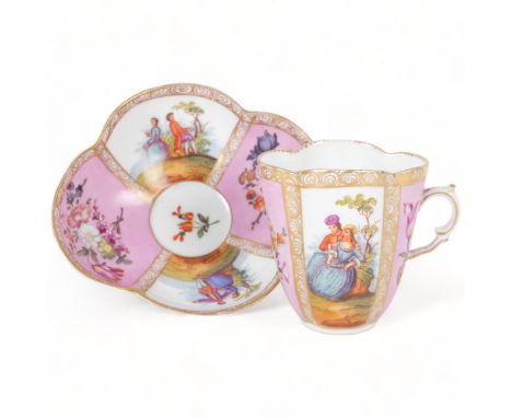 An Antique Dresden quatrefoil cup and saucer, painted pink and white panels decorated with flowers and figures, both marked D