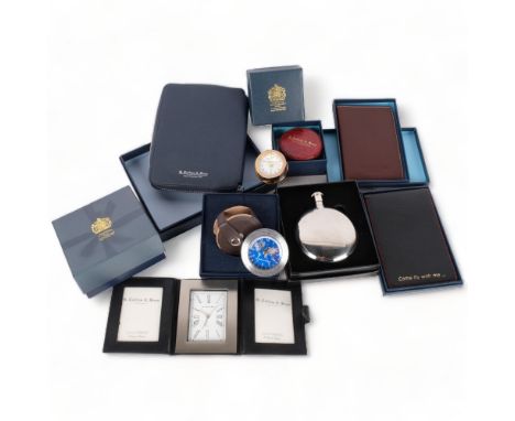 A collection of boxed gift items from Collins & Sons Jewellers of Tunbridge Wells, including spirit flask, notebook, and cloc