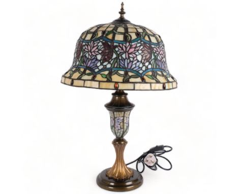 A Tiffany style table lamp, with coloured leadlight shade and centre column, on turned base, H66cm, shade width 41cm, working