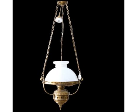 A brass oil lamp style electric light, with milk glass shade and chains, 35cm across 