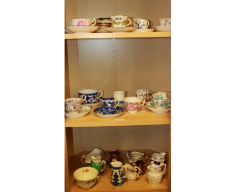 A collection of early English porcelain cups, saucers, plates and milk jugs.