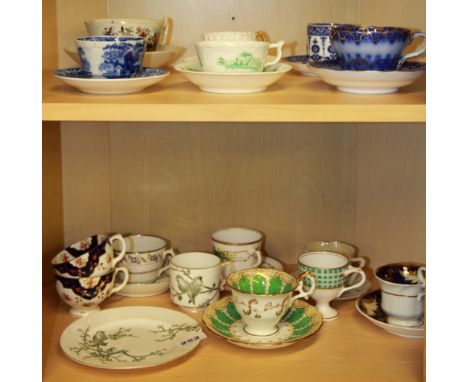 A collection of early English porcelain cups and saucers and a plate.