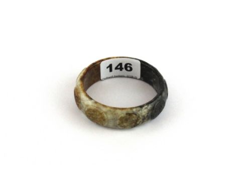 An unusual carved mixed colour jade bangle, W. 2cm  Dia. 6.5cm.