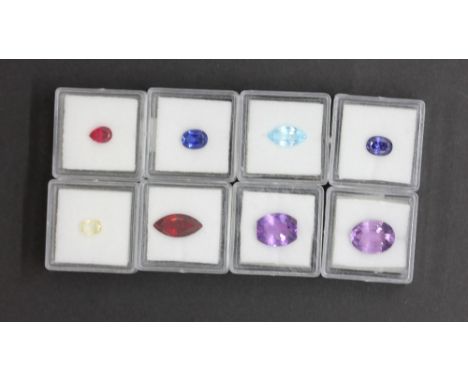 Eight individually boxed unmounted gemstones, including garnet, ruby, amethyst, sapphire, citrine, etc.